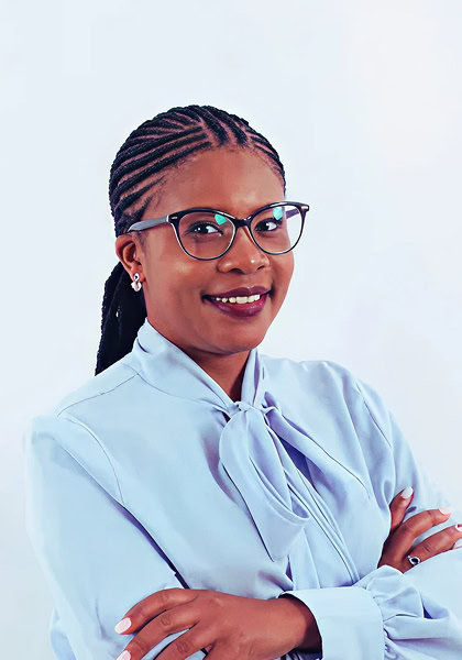 Confident woman with braided hair, wearing glasses and a blue blouse, professional headshot. Stylish businesswoman portrait.