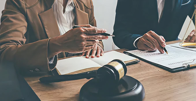 Lawyers reviewing legal documents with gavel and scales of justice. Legal consultation, attorney services.